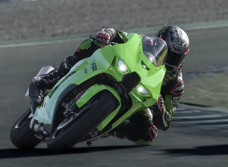 Actiefoto Kawasaki Ninja ZX-10 RR met motorrijder die op circuit hangend door de bocht rijdt.